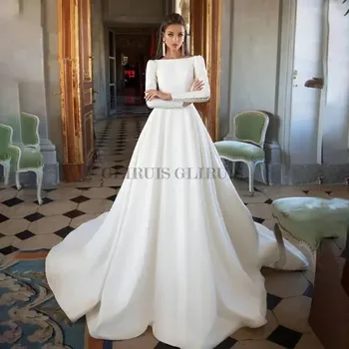 Satiiniset häämekot Selkänojaton pitkähihainen A-linjainen morsiusmekko Prinsessa vestido de noiva Avoin takaosa Tyylikäs kaapu de marie